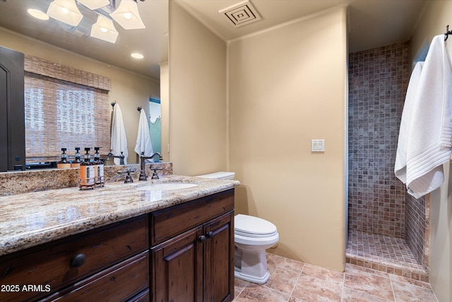 bathroom featuring toilet, a stall shower, vanity, and visible vents