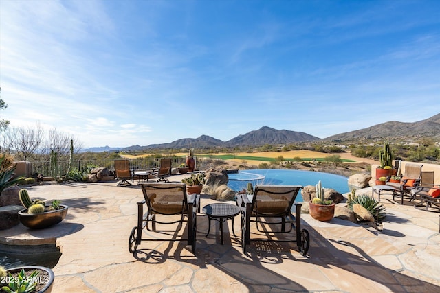 view of pool with a mountain view and a patio