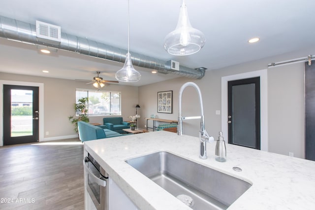 7544 E Mckinley St, Scottsdale, AZ 85257 - kitchen with visible vents, light stone countertops, recessed lighting, a sink, and hanging light fixtures
