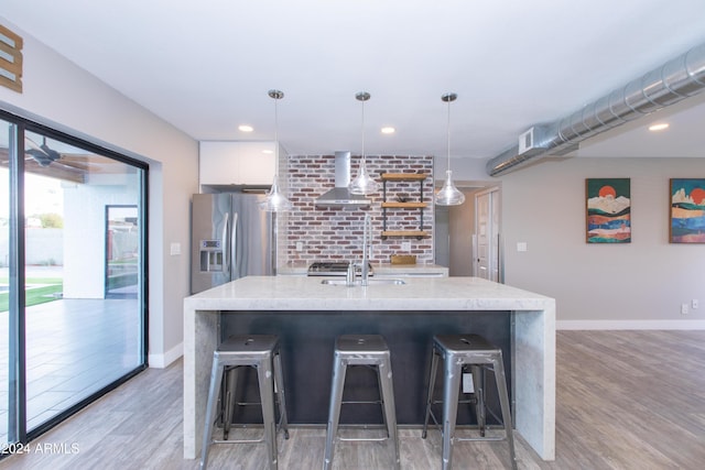 7544 E Mckinley St, Scottsdale, AZ 85257 - kitchen with stainless steel refrigerator with ice dispenser, modern cabinets, white cabinetry, light wood finished floors, and wall chimney exhaust hood