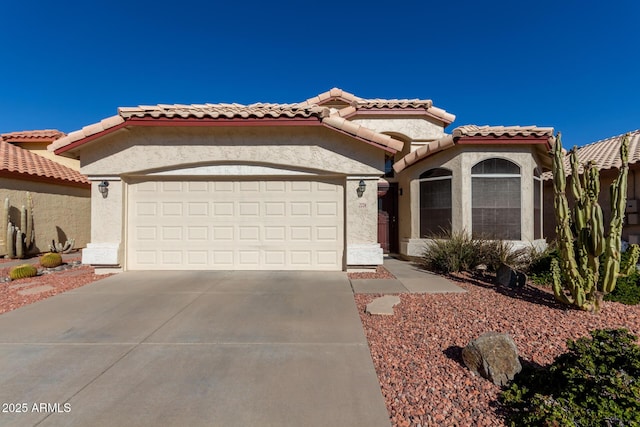 mediterranean / spanish-style home featuring a garage