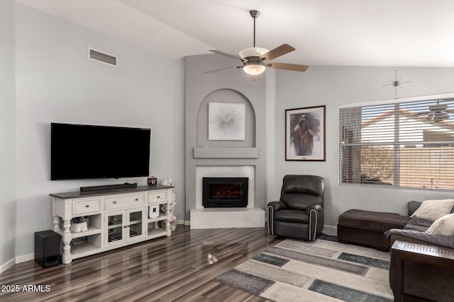 living room with a fireplace, hardwood / wood-style floors, ceiling fan, and vaulted ceiling