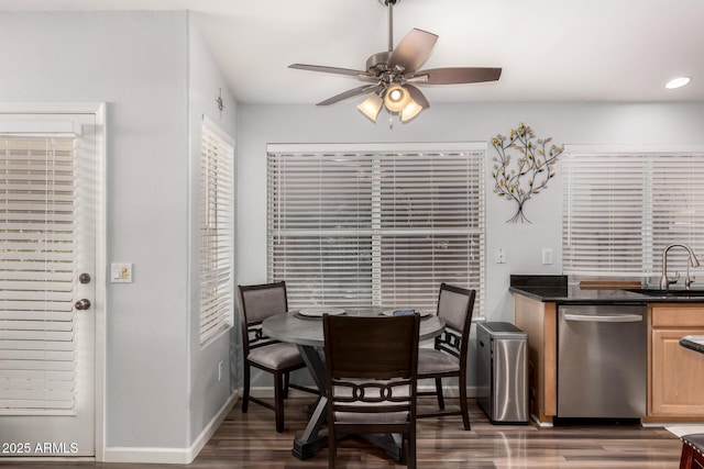 dining space with ceiling fan, dark hardwood / wood-style floors, and sink