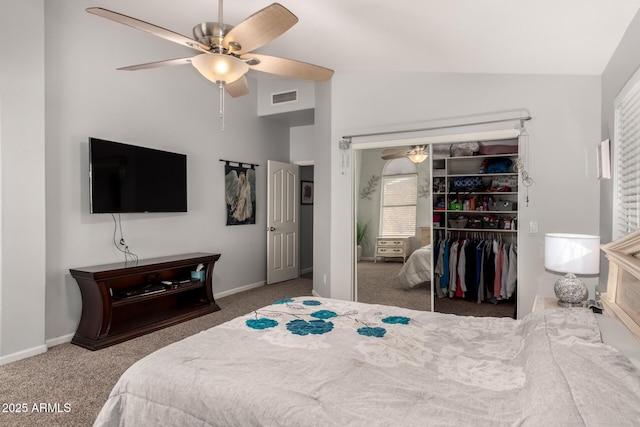 bedroom with ceiling fan, carpet, a closet, and lofted ceiling