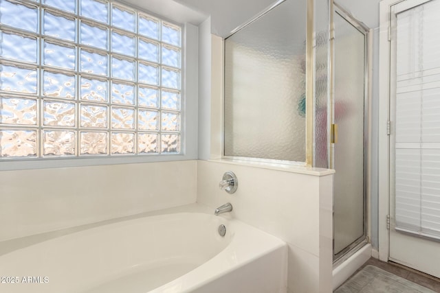 bathroom with separate shower and tub