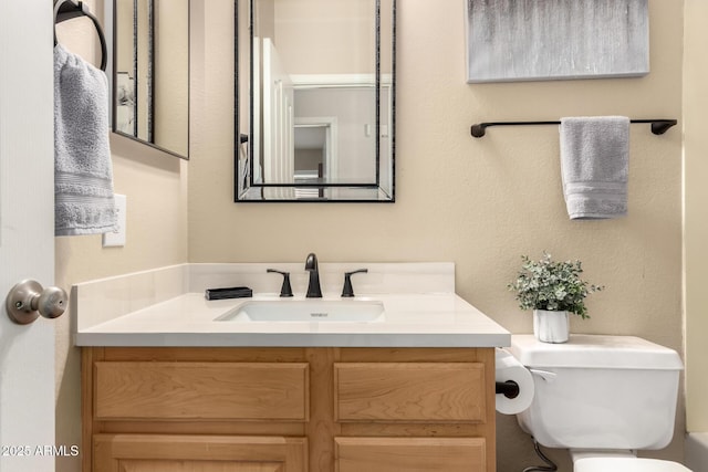 bathroom featuring toilet and vanity