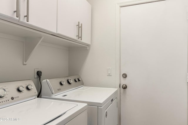 laundry area featuring independent washer and dryer and cabinets