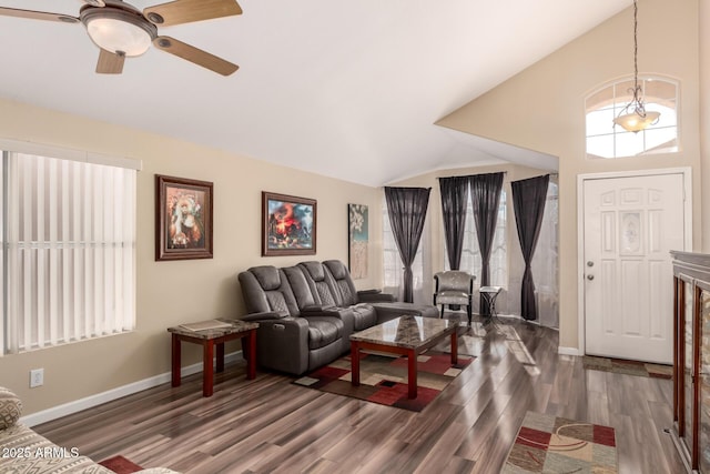 living room featuring vaulted ceiling, dark wood-type flooring, and ceiling fan