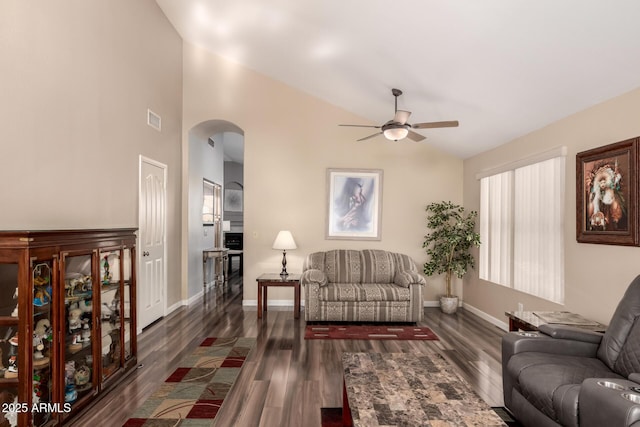 living room featuring ceiling fan, dark hardwood / wood-style flooring, and vaulted ceiling