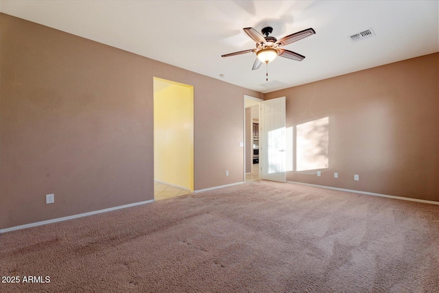 unfurnished room with light colored carpet and ceiling fan