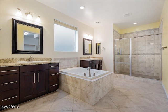 bathroom with vanity and independent shower and bath