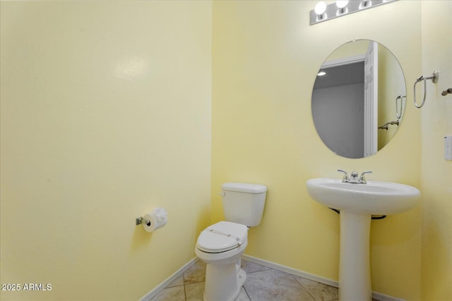 bathroom with tile patterned flooring, sink, and toilet