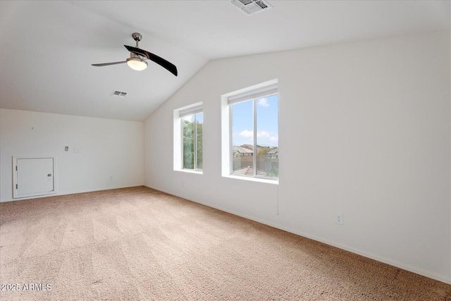 spare room with lofted ceiling, carpet flooring, and ceiling fan