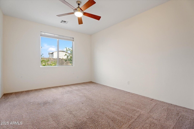 empty room with carpet floors and ceiling fan