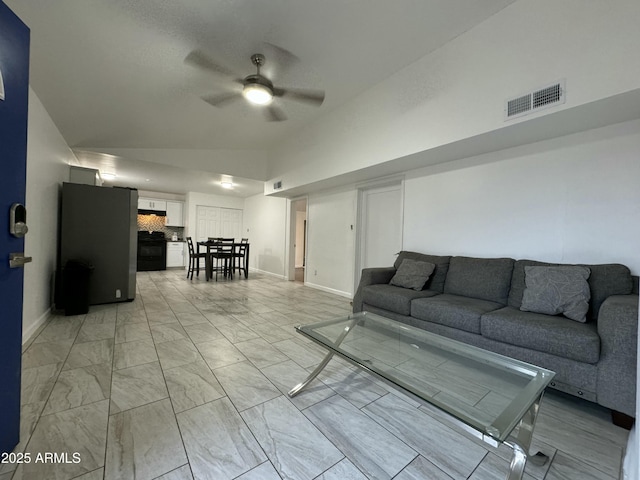 living room featuring vaulted ceiling and ceiling fan