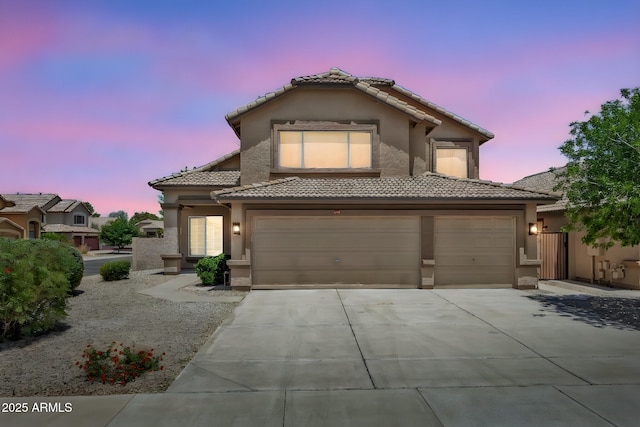 664 E Windsor Dr, Gilbert, AZ 85296 - view of front of home with a tiled roof, stucco siding, an attached garage, and driveway