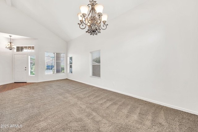 664 E Windsor Dr, Gilbert, AZ 85296 - unfurnished room with a chandelier, high vaulted ceiling, baseboards, and dark carpet