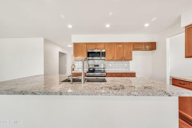 664 E Windsor Dr, Gilbert, AZ 85296 - kitchen with a sink, appliances with stainless steel finishes, light stone countertops, decorative backsplash, and recessed lighting