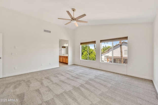 664 E Windsor Dr, Gilbert, AZ 85296 - spare room featuring ceiling fan, light carpet, lofted ceiling, and baseboards