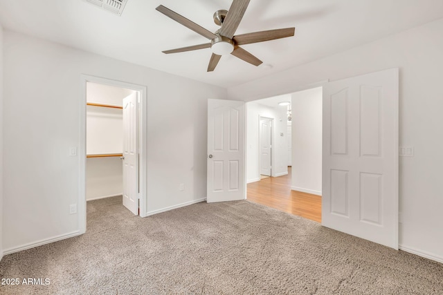 664 E Windsor Dr, Gilbert, AZ 85296 - unfurnished bedroom featuring carpet floors, a walk in closet, baseboards, and a ceiling fan