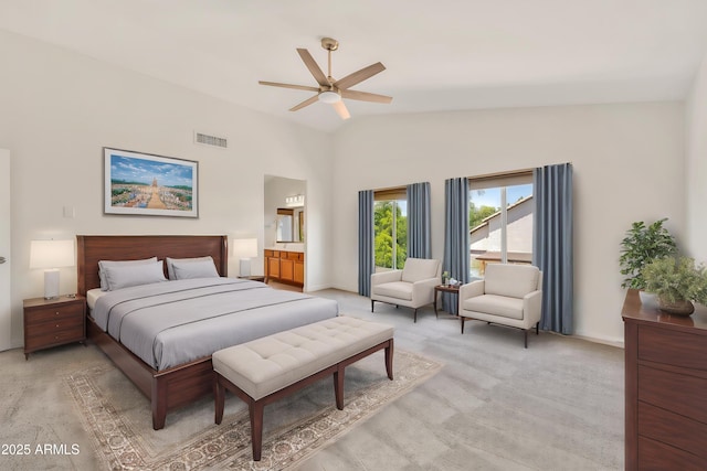 664 E Windsor Dr, Gilbert, AZ 85296 - bedroom with light colored carpet, lofted ceiling, baseboards, ceiling fan, and ensuite bath