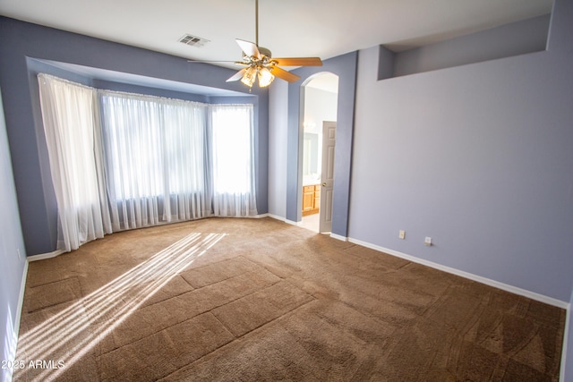 carpeted spare room with ceiling fan