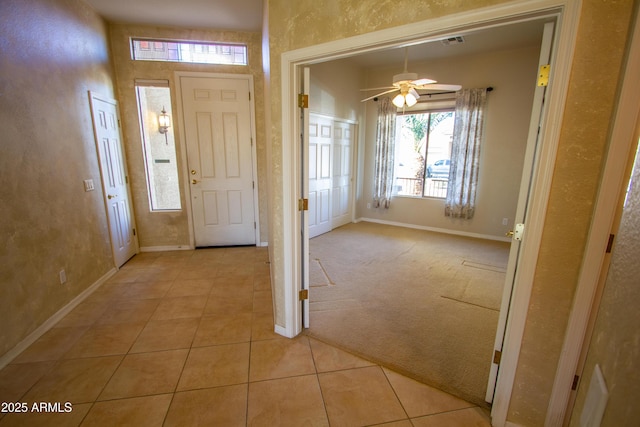 foyer featuring ceiling fan and light tile patterned floors