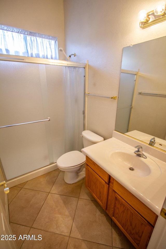 bathroom with an enclosed shower, tile patterned floors, and toilet