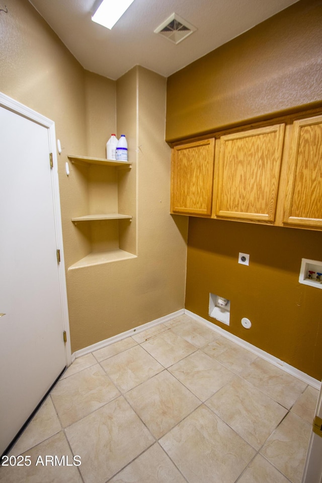 clothes washing area featuring washer hookup, cabinets, light tile patterned floors, and hookup for an electric dryer