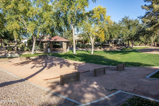 view of property's community with a gazebo and a yard