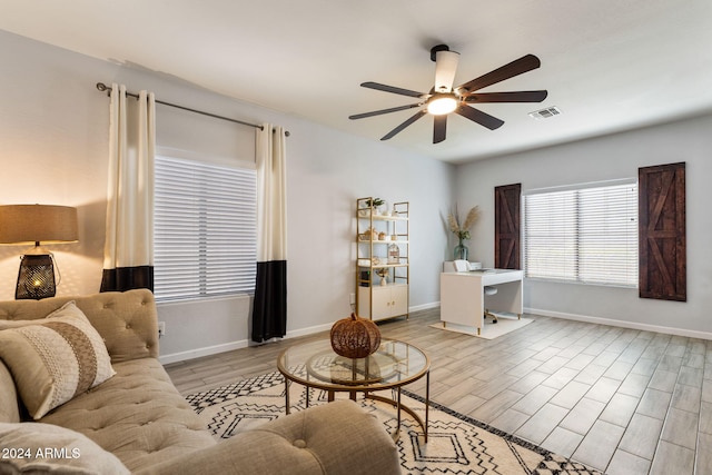 living room with light hardwood / wood-style floors and ceiling fan