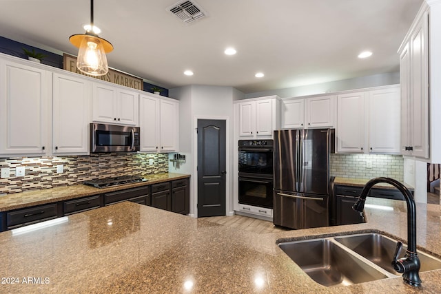 kitchen featuring stone counters, sink, white cabinetry, and stainless steel appliances