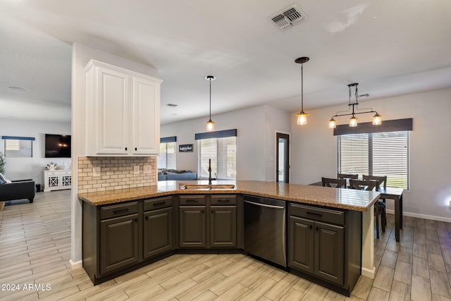 kitchen featuring kitchen peninsula, dark brown cabinets, decorative light fixtures, stainless steel dishwasher, and white cabinets