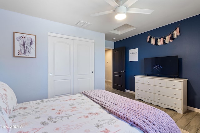 bedroom with a closet, ceiling fan, and hardwood / wood-style flooring