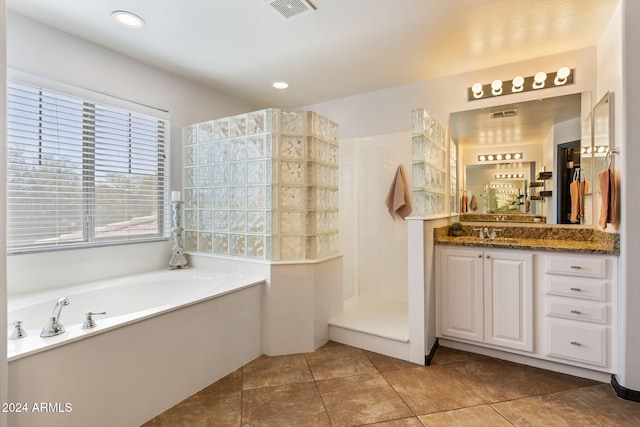 bathroom with vanity, independent shower and bath, and tile patterned floors