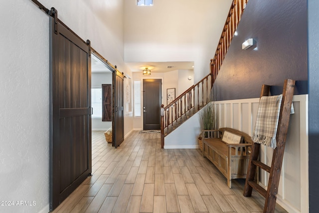 entryway featuring a barn door and light wood-type flooring