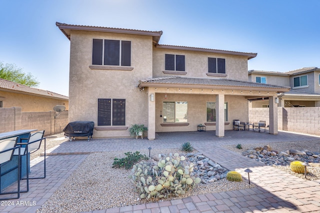 rear view of house featuring a patio