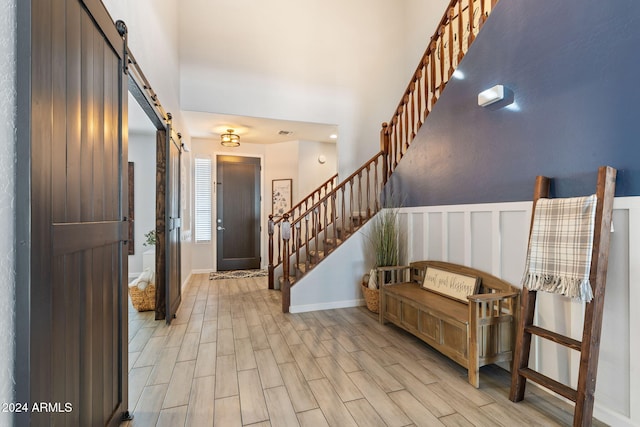 entryway featuring a barn door and light wood-type flooring