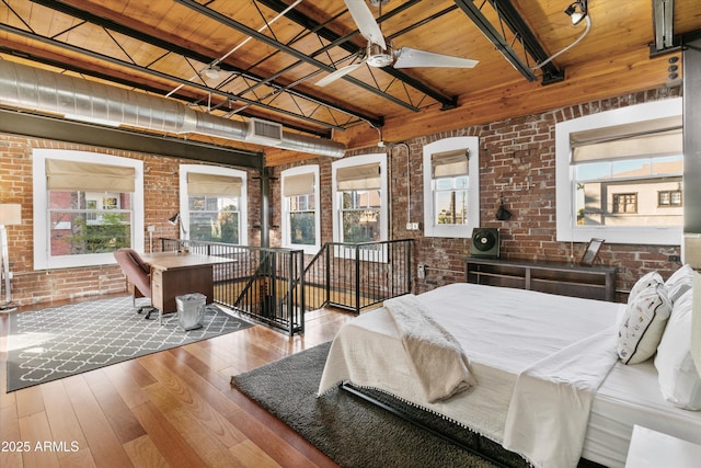 bedroom featuring wood ceiling and brick wall