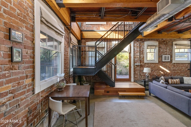 interior space featuring concrete flooring and brick wall