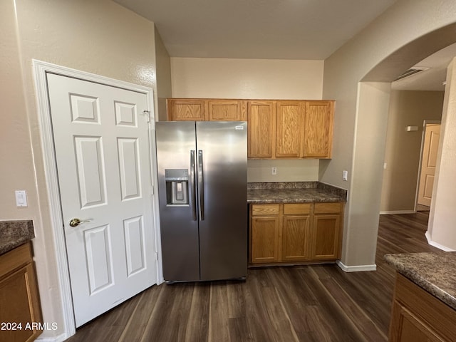 kitchen featuring stainless steel fridge and dark wood-type flooring