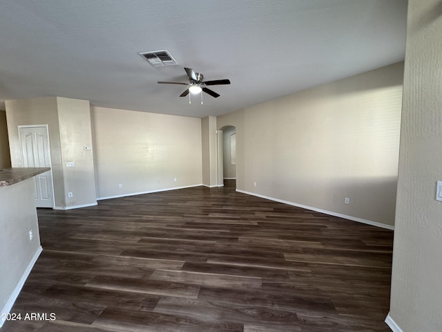 empty room featuring ceiling fan and dark wood-type flooring