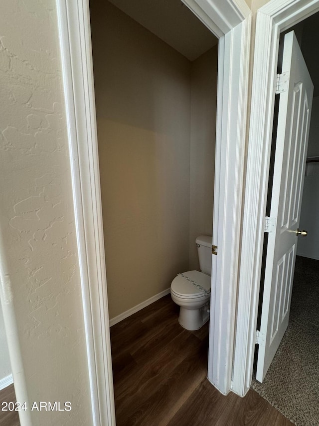 bathroom featuring toilet and hardwood / wood-style flooring