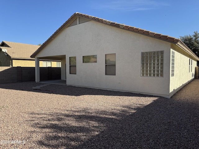 back of house with a carport