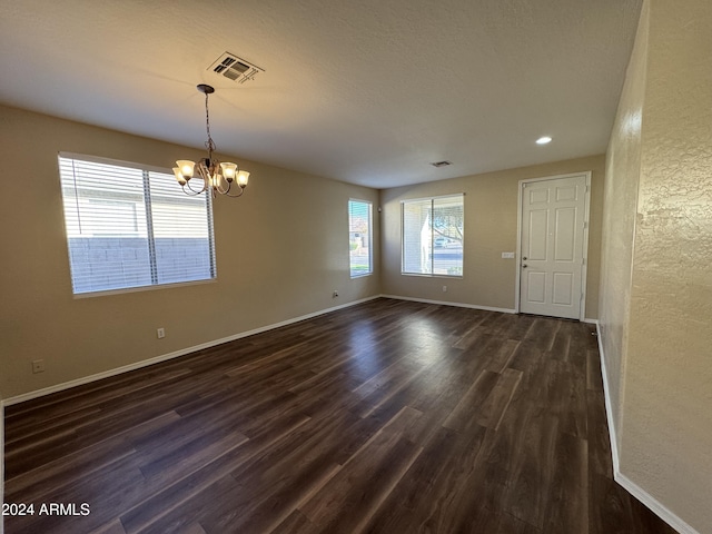 interior space with dark hardwood / wood-style floors and an inviting chandelier