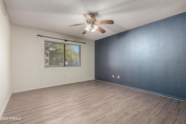 2146 W Isabella Ave Unit 131, Mesa, AZ 85202 - spare room featuring wood finished floors, a textured ceiling, a ceiling fan, and baseboards