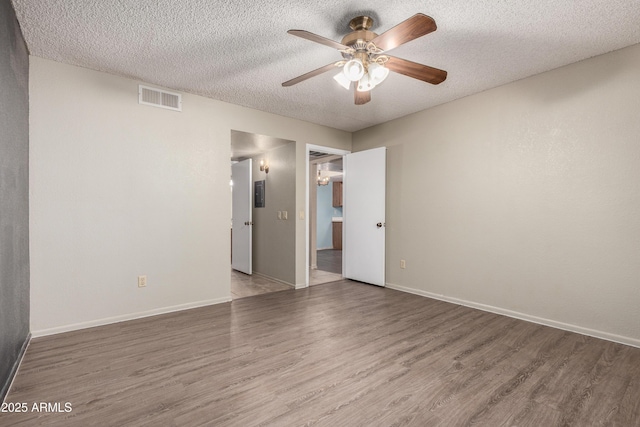 2146 W Isabella Ave Unit 131, Mesa, AZ 85202 - empty room with a textured ceiling, baseboards, visible vents, wood finished floors, and ceiling fan