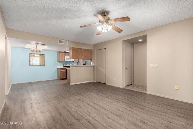 2146 W Isabella Ave Unit 131, Mesa, AZ 85202 - unfurnished living room featuring baseboards, wood finished floors, visible vents, and a textured ceiling