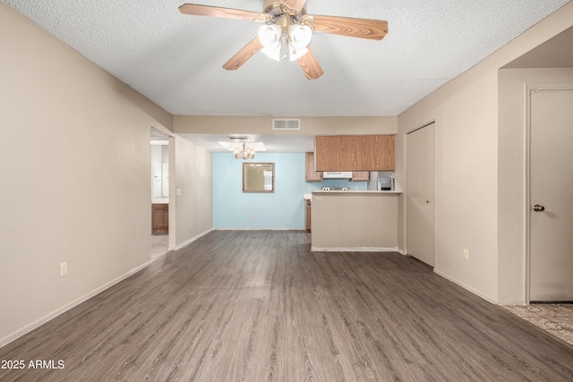 2146 W Isabella Ave Unit 131, Mesa, AZ 85202 - unfurnished living room featuring dark wood-style floors, a ceiling fan, a textured ceiling, baseboards, and visible vents