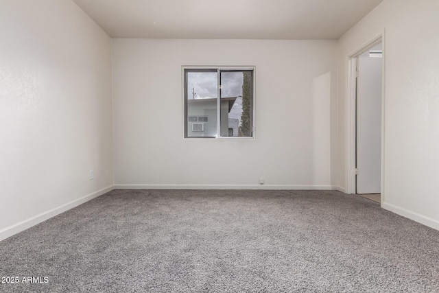 carpeted empty room with baseboards